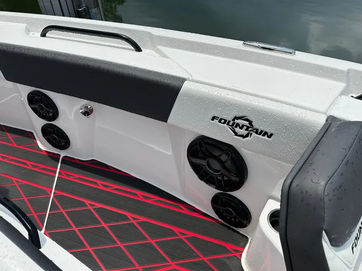  Yacht Photos Pics 2024 Fountain 32 NX boat interior with speakers and red-accented flooring.