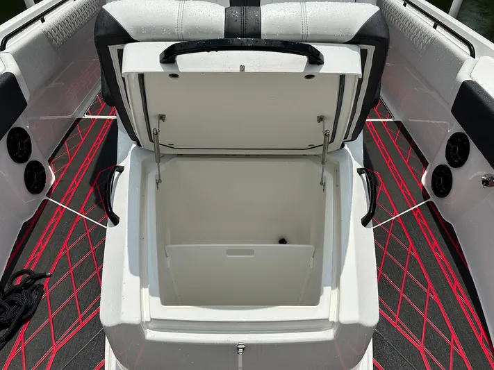  Yacht Photos Pics Open storage compartment on 2024 Fountain 32 NX boat with red and black interior accents.