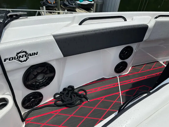  Yacht Photos Pics 2024 Fountain 32 NX boat interior with speakers and red-accented flooring.