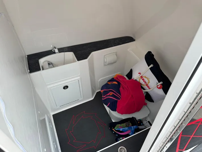  Yacht Photos Pics 2024 Fountain 32 NX cabin interior with sink, storage, and colorful cushions.