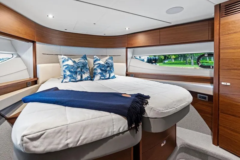 Hullabaloo Yacht Photos Pics Luxurious 2021 Princess V55 yacht bedroom with elegant wood finish and stylish decor.