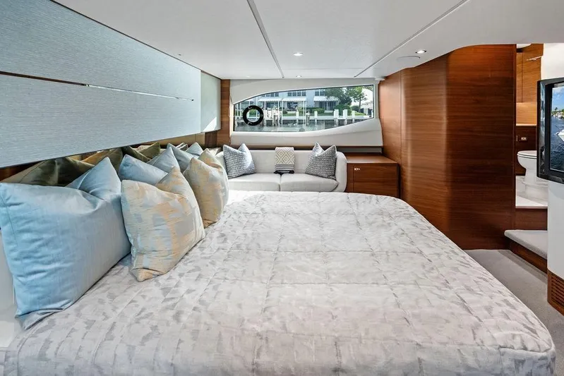 Hullabaloo Yacht Photos Pics Luxurious interior of 2021 Princess V55 yacht with elegant bedding and modern design.