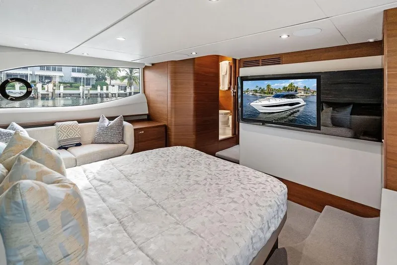 Hullabaloo Yacht Photos Pics Luxurious 2021 Princess V55 yacht interior with cozy bedroom and scenic window view.