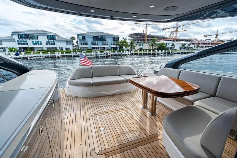 Hullabaloo Yacht Photos Pics Luxurious 2021 Princess V55 yacht interior with elegant seating and waterfront view.