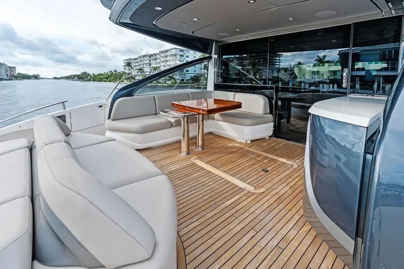 Hullabaloo Yacht Photos Pics Luxurious 2021 Princess V55 yacht deck with elegant seating and wooden flooring.