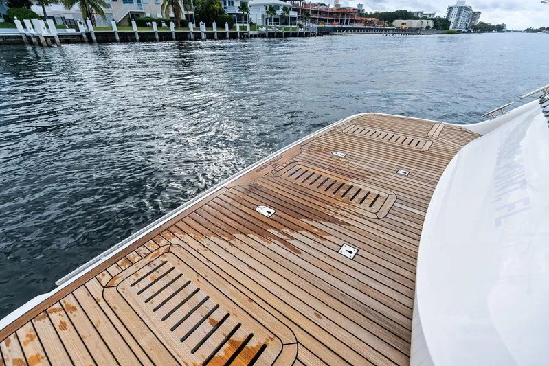 Hullabaloo Yacht Photos Pics Teak deck of 2021 Princess V55 yacht by the water.