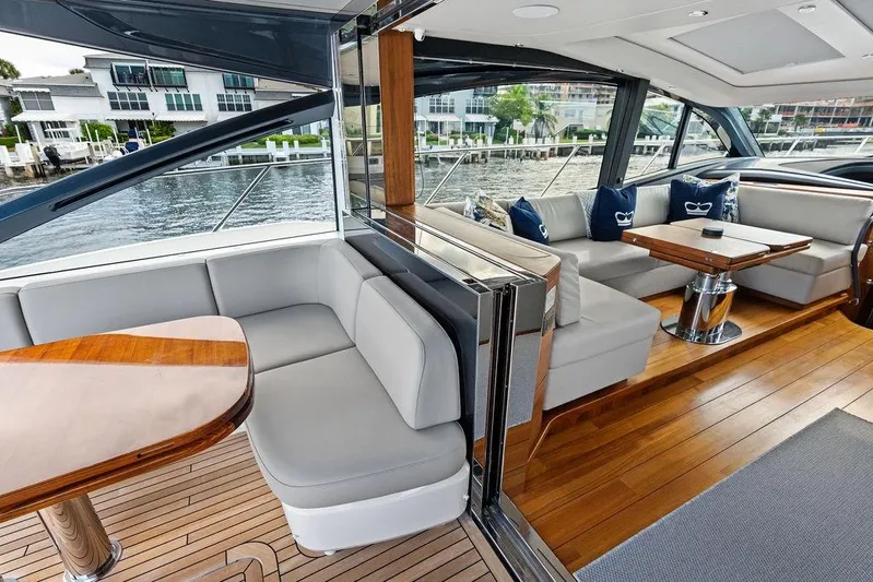 Hullabaloo Yacht Photos Pics Luxurious interior of 2021 Princess V55 yacht with elegant seating and wooden flooring.