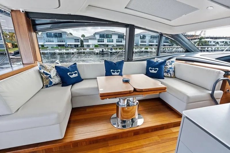 Hullabaloo Yacht Photos Pics Luxurious interior of 2021 Princess V55 yacht with elegant seating and scenic view.