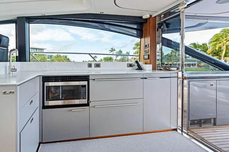 Hullabaloo Yacht Photos Pics Modern kitchen interior on 2021 Princess V55 yacht with sleek cabinetry and appliances.