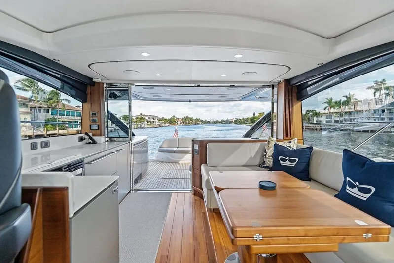 Hullabaloo Yacht Photos Pics Luxurious interior of 2021 Princess V55 yacht with elegant seating and scenic water view.