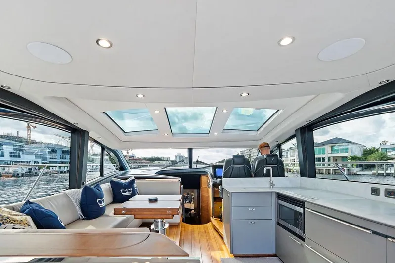 Hullabaloo Yacht Photos Pics Luxurious interior of 2021 Princess V55 yacht with skylights and modern amenities.