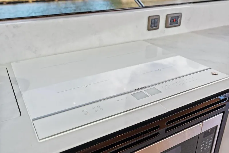 Hullabaloo Yacht Photos Pics Modern kitchen appliance on 2021 Princess V55 yacht, featuring sleek design and advanced controls.