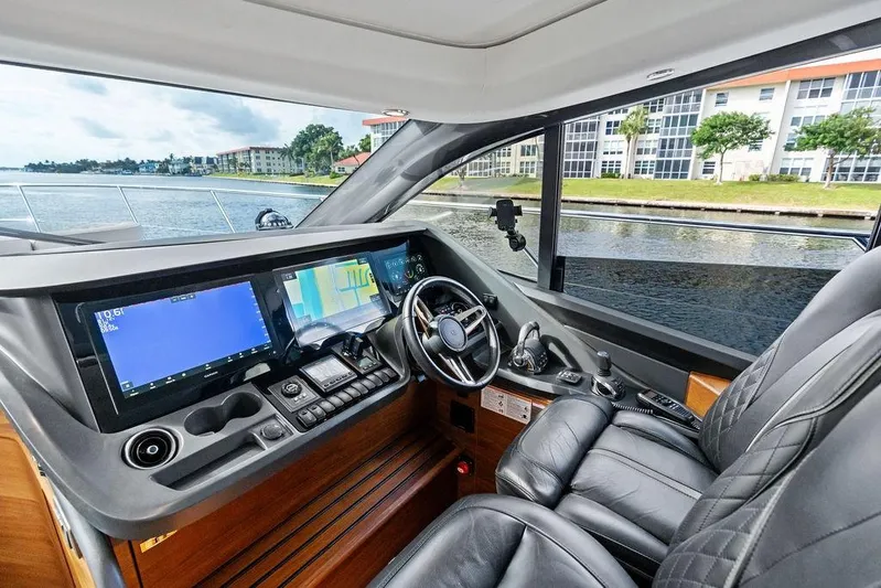 Hullabaloo Yacht Photos Pics Luxurious 2021 Princess V55 yacht cockpit with advanced navigation systems and leather seating.