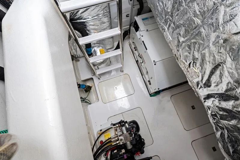 Hullabaloo Yacht Photos Pics Engine room of 2021 Princess V55 yacht with ladder and equipment.