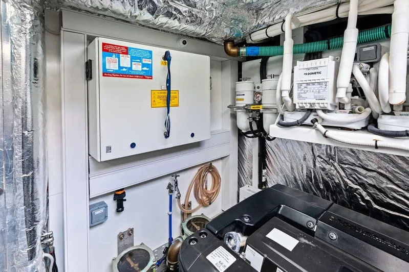 Hullabaloo Yacht Photos Pics Engine room of 2021 Princess V55 yacht with control panels and piping.