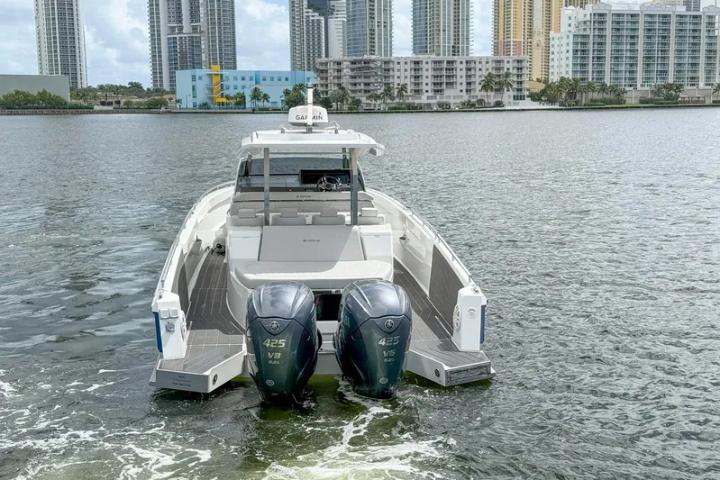  Yacht Photos Pics 2024 Opus OPUS 12 boat with dual engines on a city waterfront.