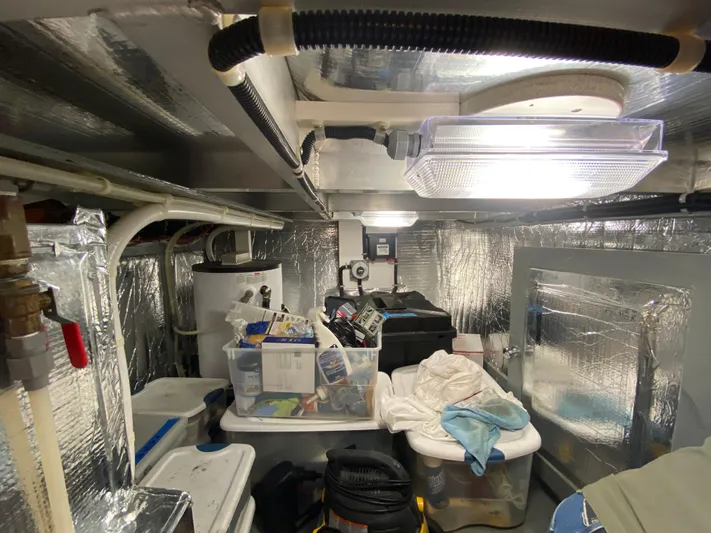 Coldwater Fusion Yacht Photos Pics Engine room of 1998 Navigator 5300 Classic with storage bins and equipment.