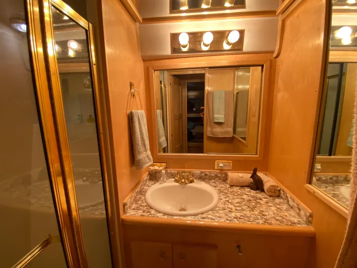 Coldwater Fusion Yacht Photos Pics Luxurious head in 1998 Navigator 5300 Classic yacht with elegant lighting and marble countertop.