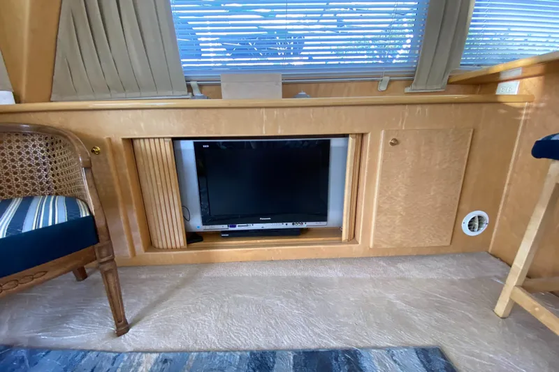 Coldwater Fusion Yacht Photos Pics Interior of 1998 Navigator 5300 Classic yacht with built-in TV and wooden cabinetry.