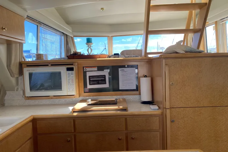 Coldwater Fusion Yacht Photos Pics Interior of 1998 Navigator 5300 Classic yacht galley with microwave and wooden cabinetry.