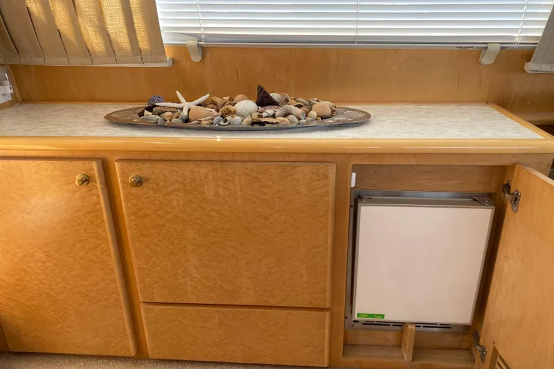 Coldwater Fusion Yacht Photos Pics 1998 Navigator 5300 Classic interior with seashell decor on wooden cabinetry.