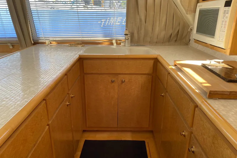 Coldwater Fusion Yacht Photos Pics 1998 Navigator 5300 Classic galley with wood cabinets, countertop, and microwave.