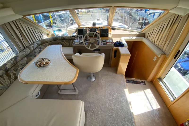 Coldwater Fusion Yacht Photos Pics Interior of 1998 Navigator 5300 Classic yacht with helm, seating, and table.