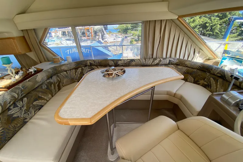 Coldwater Fusion Yacht Photos Pics Interior of 1998 Navigator 5300 Classic yacht with elegant seating and table.