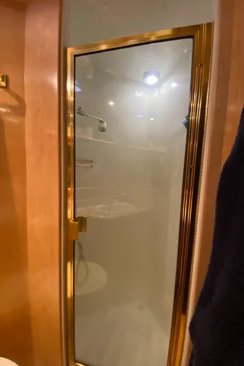 Coldwater Fusion Yacht Photos Pics Separate shower area in 1998 Navigator 5300 Classic yacht with glass door and gold trim.