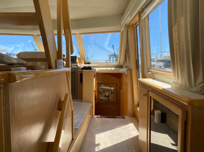 Coldwater Fusion Yacht Photos Pics Interior of 1998 Navigator 5300 Classic yacht with wooden finishes and large windows.