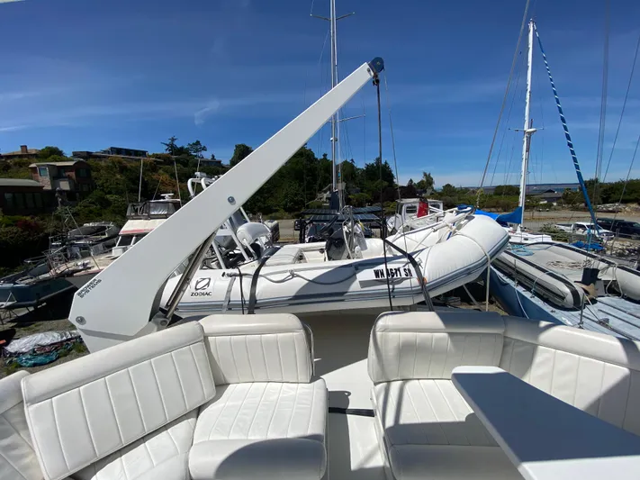 Coldwater Fusion Yacht Photos Pics 1998 Navigator 5300 Classic yacht with white seating and tender on deck.