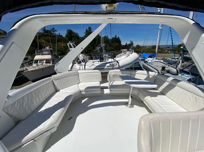 Coldwater Fusion Yacht Photos Pics Spacious deck of 1998 Navigator 5300 Classic yacht with white seating and table.