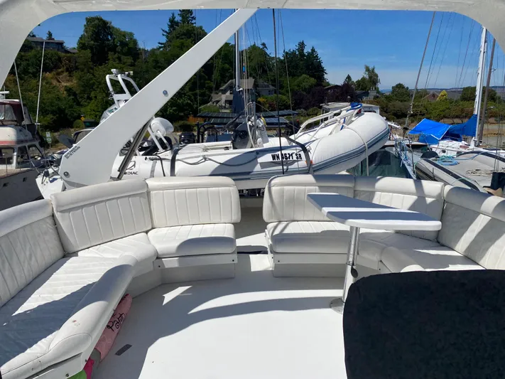 Coldwater Fusion Yacht Photos Pics 1998 Navigator 5300 Classic yacht with white seating and table on deck, docked in marina.