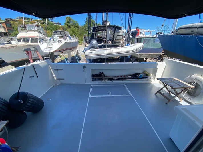 Coldwater Fusion Yacht Photos Pics Spacious deck of 1998 Navigator 5300 Classic yacht, docked with other boats.