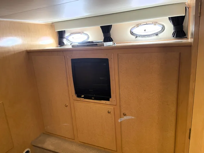 Coldwater Fusion Yacht Photos Pics Interior of 1998 Navigator 5300 Classic yacht with built-in TV and porthole windows.