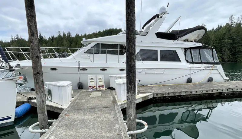 Coldwater Fusion Yacht Photos Pics 1998 Navigator 5300 Classic yacht docked at marina with forest backdrop.