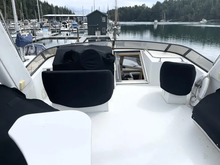 Coldwater Fusion Yacht Photos Pics 1998 Navigator 5300 Classic yacht deck with covered seating, docked in a serene marina.