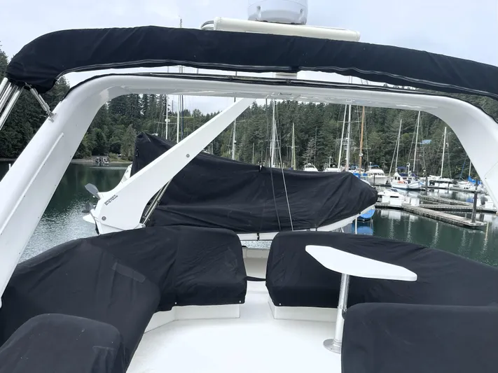 Coldwater Fusion Yacht Photos Pics 1998 Navigator 5300 Classic yacht with covered seating, docked in a serene marina.