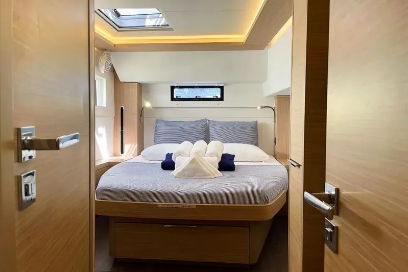 Artemis Yacht Photos Pics Luxurious cabin interior of 2023 Lagoon 46 yacht with cozy bed and modern design.