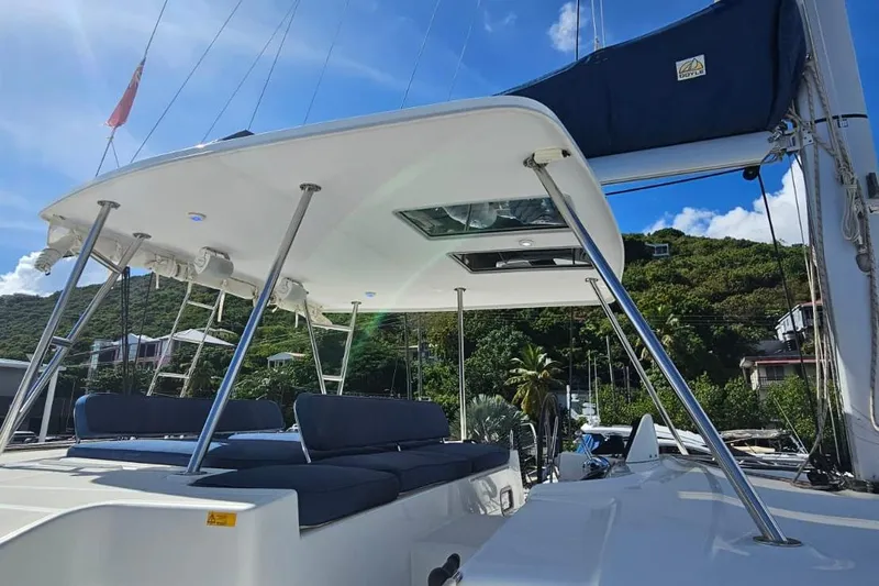 Artemis Yacht Photos Pics 2023 Lagoon 46 catamaran deck with seating, under clear blue sky.