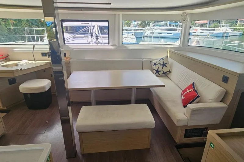 Artemis Yacht Photos Pics 2023 Lagoon 46 yacht interior with modern seating and nautical decor.