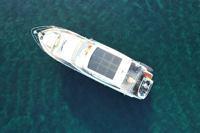  Yacht Photos Pics Aerial view of 2024 Absolute 60 Fly yacht on clear blue water.