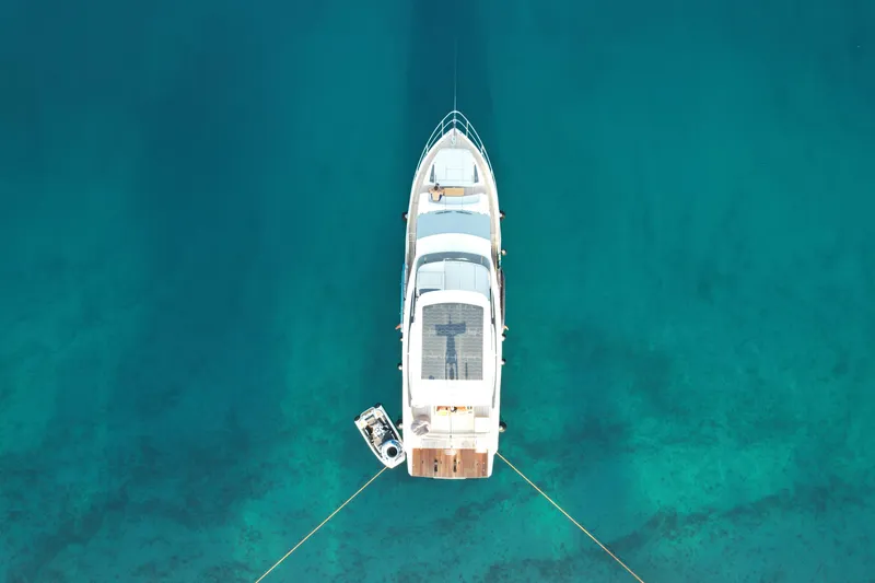  Yacht Photos Pics Aerial view of 2024 Absolute 60 Fly yacht on clear turquoise water.