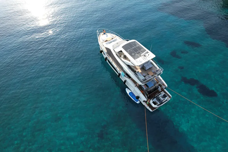  Yacht Photos Pics Aerial view of 2024 Absolute 60 Fly yacht on clear blue water.