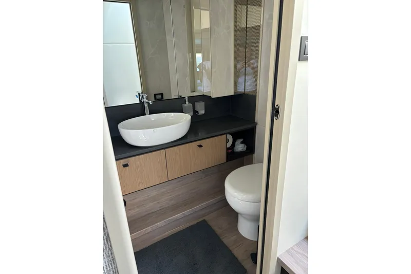  Yacht Photos Pics Luxurious bathroom in 2024 Absolute 60 Fly yacht with modern fixtures and elegant design.