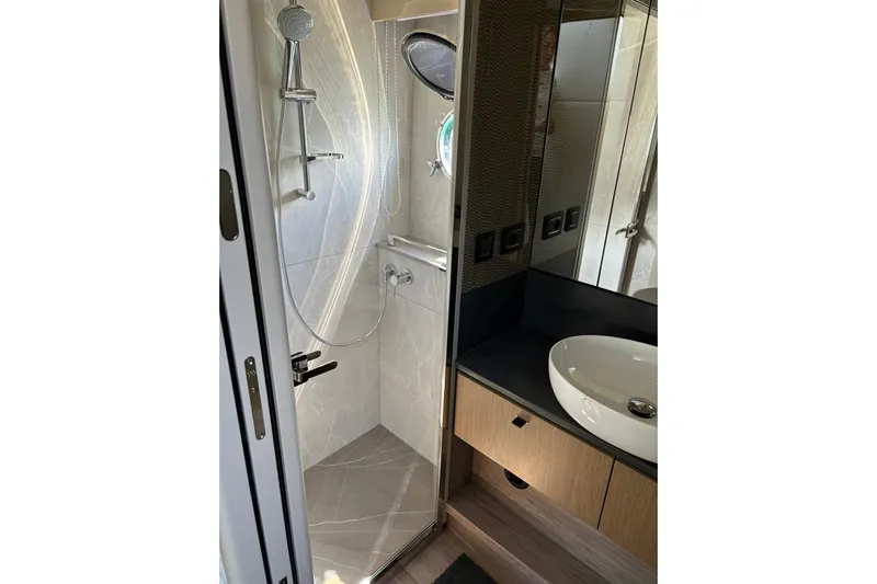  Yacht Photos Pics Luxurious bathroom in 2024 Absolute 60 Fly yacht with modern shower and sleek sink design.