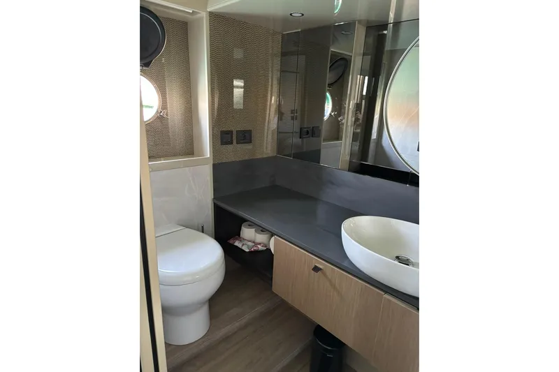  Yacht Photos Pics Luxurious bathroom in 2024 Absolute 60 Fly yacht with modern fixtures and elegant design.