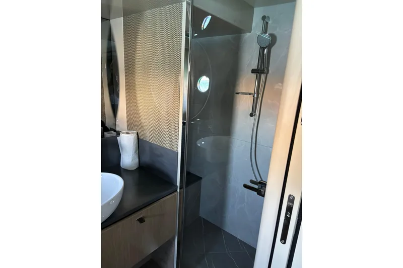  Yacht Photos Pics Luxurious bathroom in 2024 Absolute 60 Fly yacht with modern shower and sleek design.