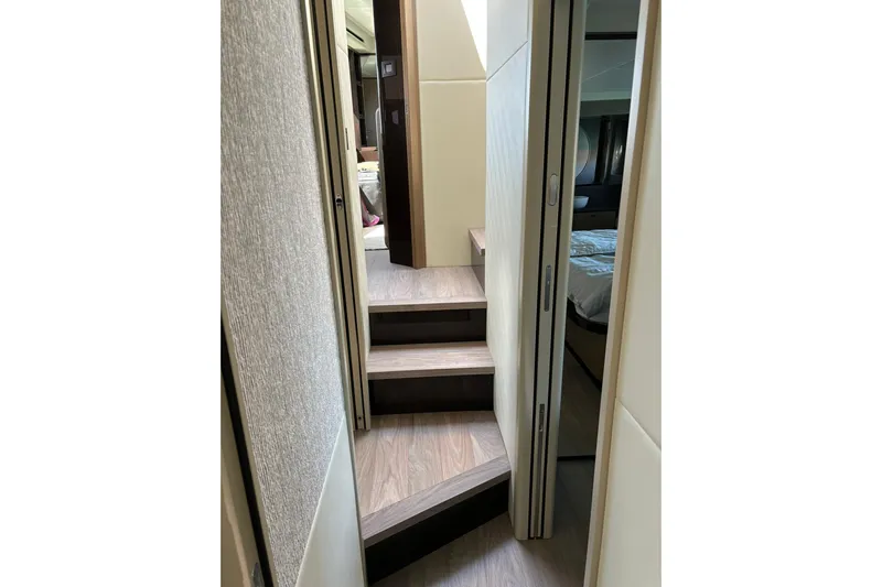  Yacht Photos Pics Interior view of 2024 Absolute 60 Fly yacht, featuring modern wooden stairs and elegant design.