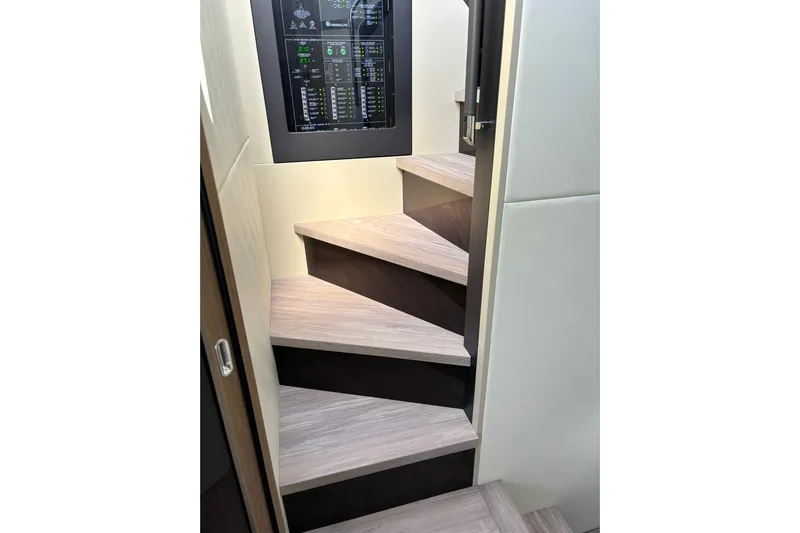  Yacht Photos Pics Staircase inside 2024 Absolute 60 Fly yacht with modern control panel.